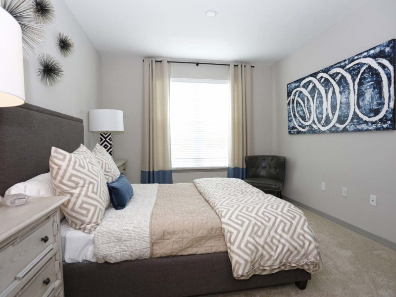 This image shows the premium feature in the bedroom area that is spacious and well decorated. The lights illuminate the hanging paint that makes the beautiful room brighter.