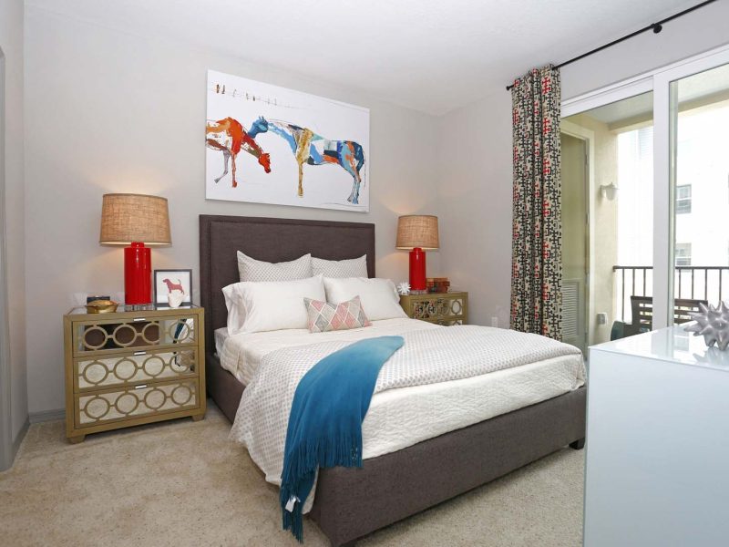 This image shows the premium feature in the bedroom area that is spacious, well decorated, and accessible to the balcony.
