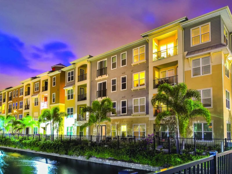 This image shows the landscape view of the TGM Ibis Walk Apartment at night, highlighting the reflection of the lights to the lake.